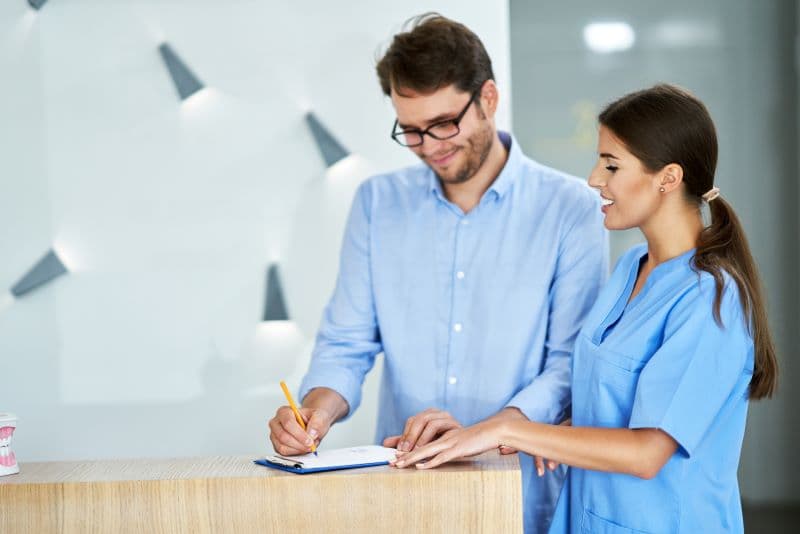 A couple comparing health coverage options on a laptop at home